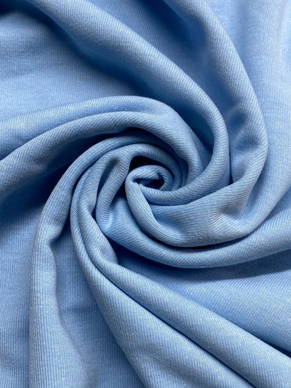 Close-up of soft sky-blue premium cotton jersey knit
