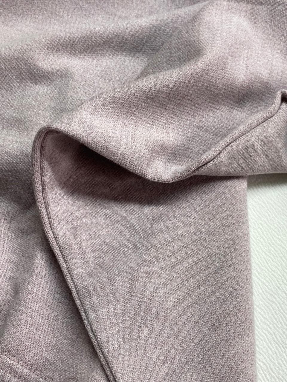 Macro close-up of crisp white high-GSM cotton jersey